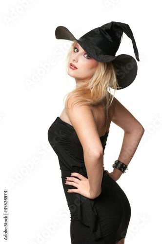 beautiful witch holds a hat