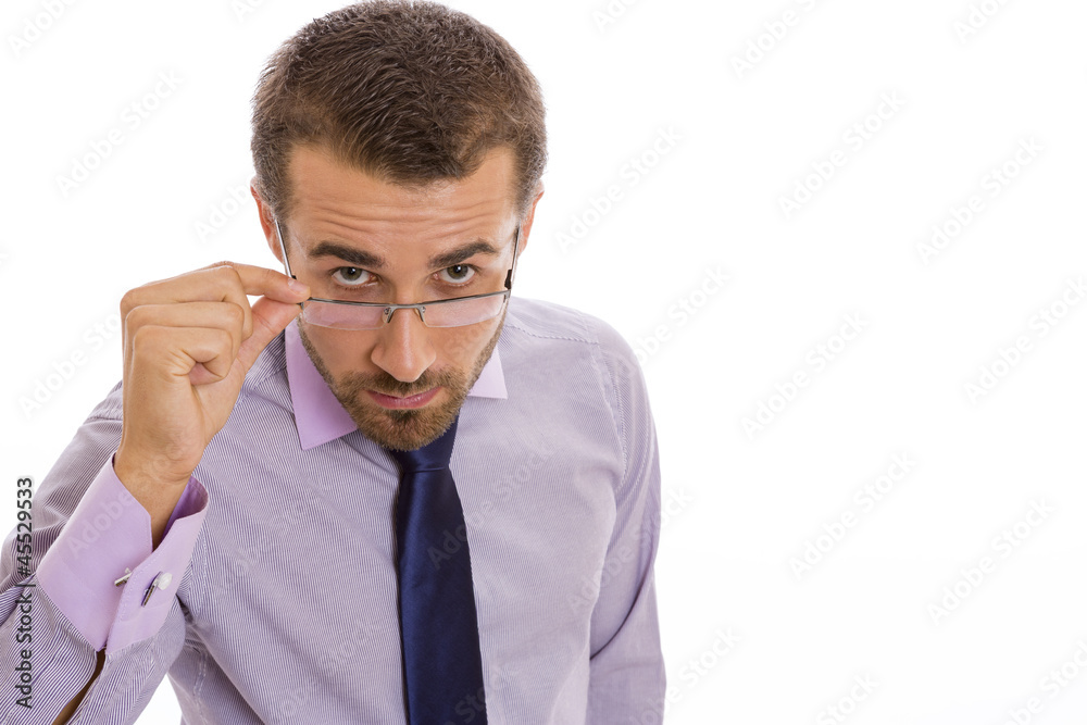 Serious businessman looking over eyeglasses Serious businessman looking over eyeglasses
