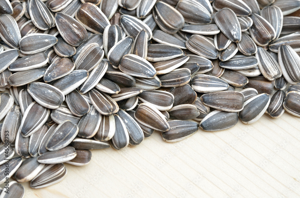 Grains of sunflower seed on wood background Grains of sunflower seed on wood background