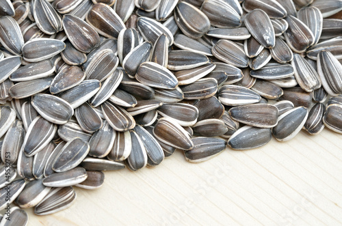 Obraz na plátně Grains of sunflower seed on wood background
