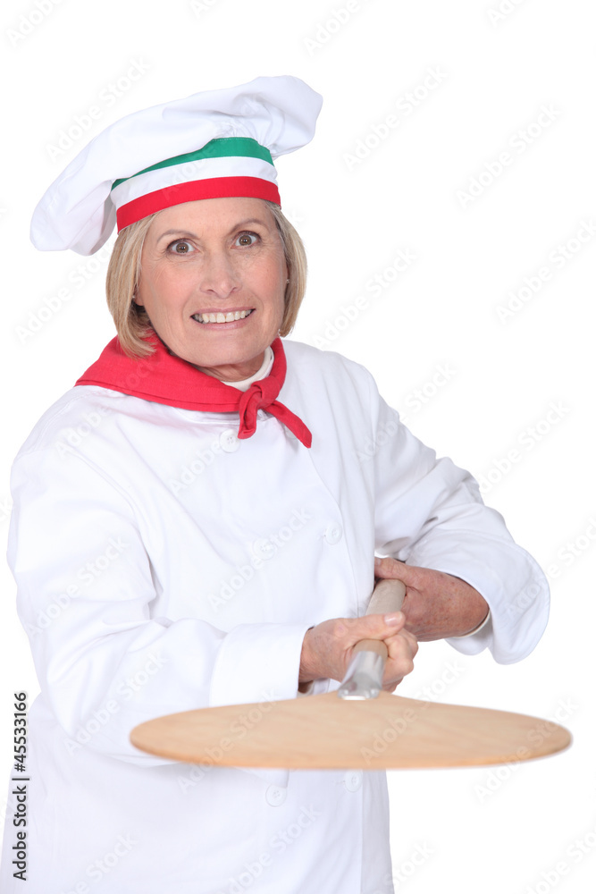 Senior pizza chef holding a pizza loading peel Senior pizza chef holding a pizza loading peel