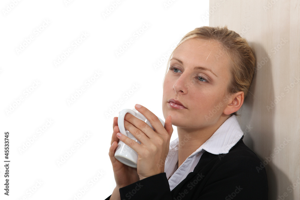 Businesswoman taking five minutes with a hot drink Businesswoman taking five minutes with a hot drink