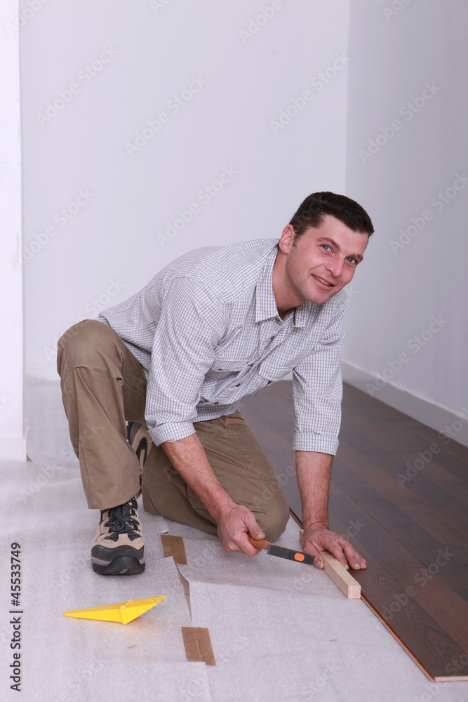 Man laying wooden flooring Man laying wooden flooring