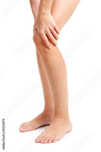 woman holding sore leg, isolated on white © Africa Studio