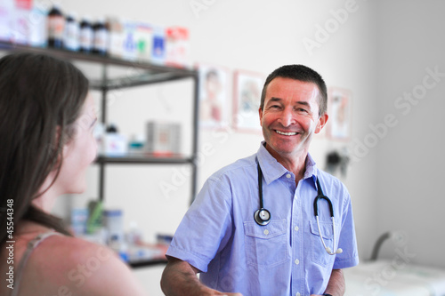 Smiling Male Doctor Helping Woman