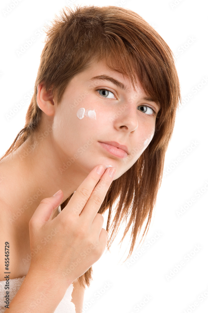Woman applying facial cream Woman applying facial cream