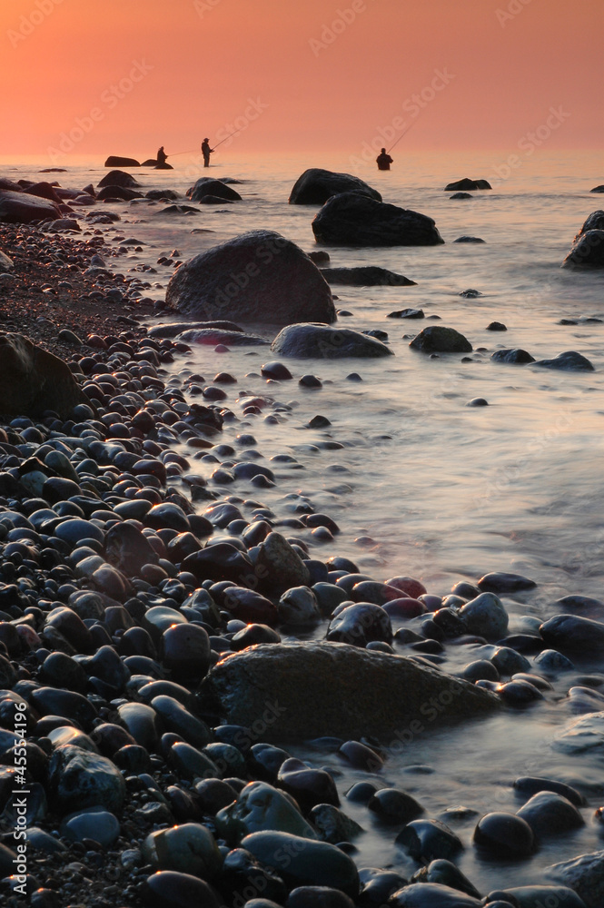 Group of fisherman at beach during sunset Group of fisherman at beach during sunset