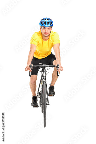 Full length portrait of a man with helmet riding a bycicle
