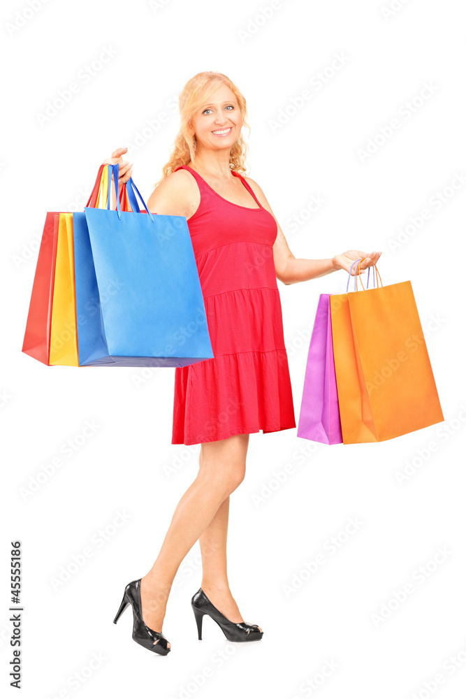 Full length portrait of a mature woman holding shopping bags