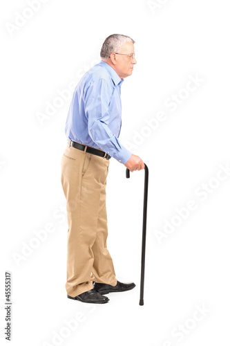 Full length portrait of a senior man walking with a cane