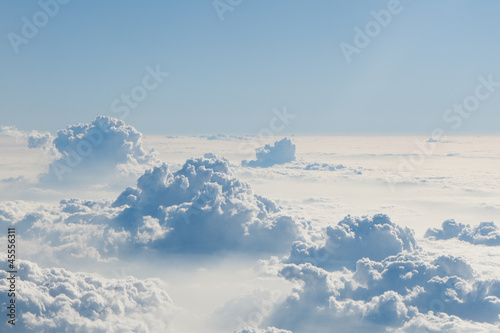 View of blue sky above fluffy clouds. photo