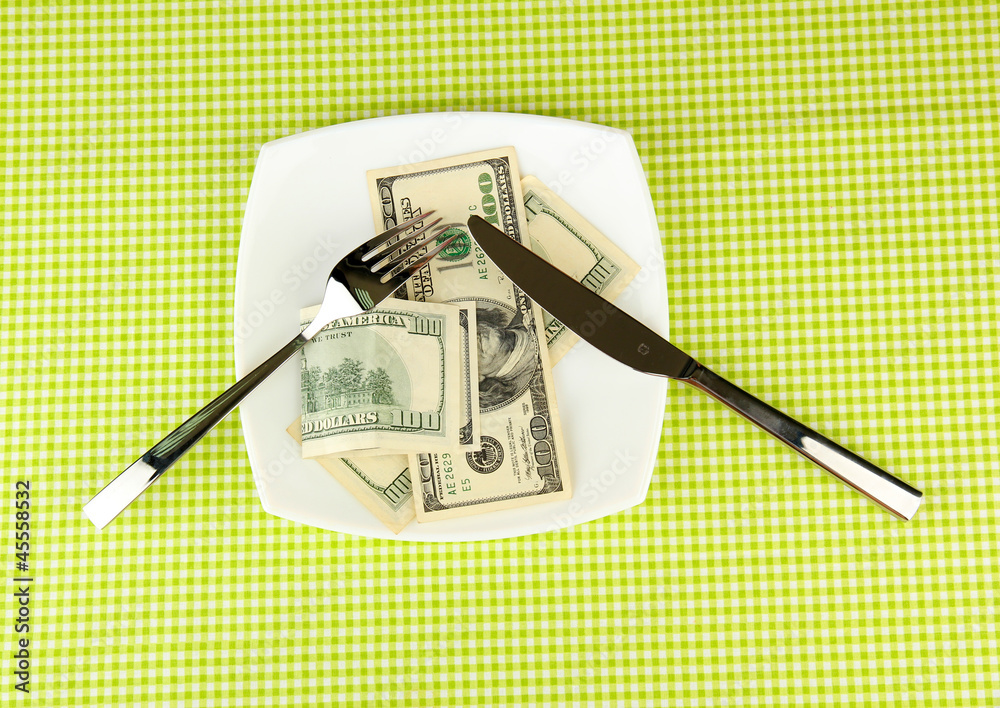 Banknotes on the plate on green tablecloth close-up Banknotes on the plate on green tablecloth close-up