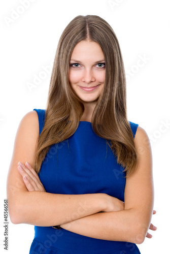 Portrait of young smiling female standing with folded hands © kanzefar