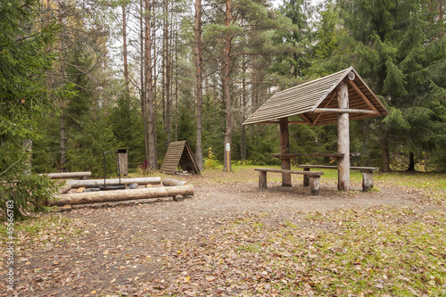 Camping area with benches and shelter in forest