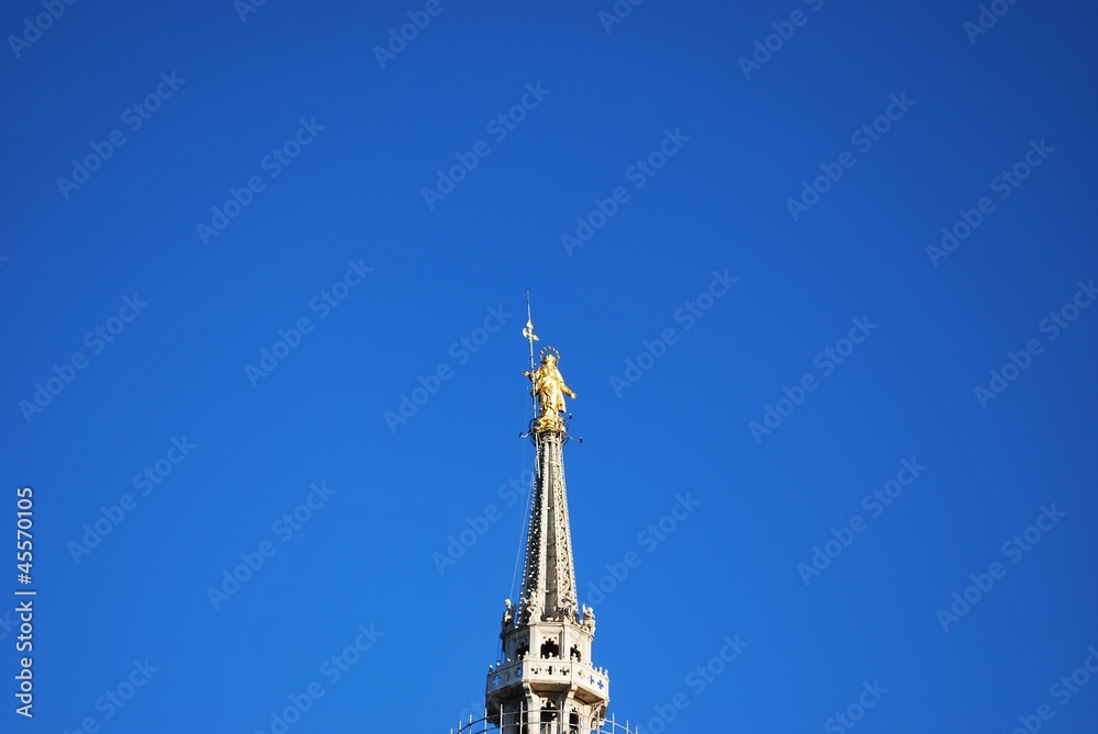 Holy Mary glod statue on cathedral of Milan, Italy Holy Mary glod statue on cathedral of Milan, Italy