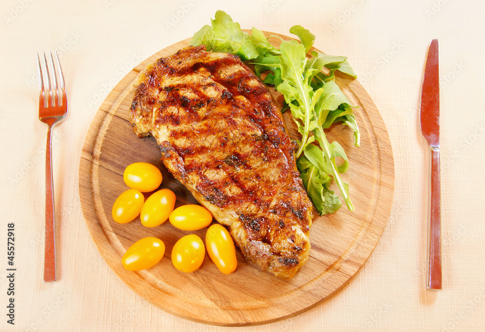 Ribeye steak with fresh greenery and tomatoes Ribeye steak with fresh greenery and tomatoes