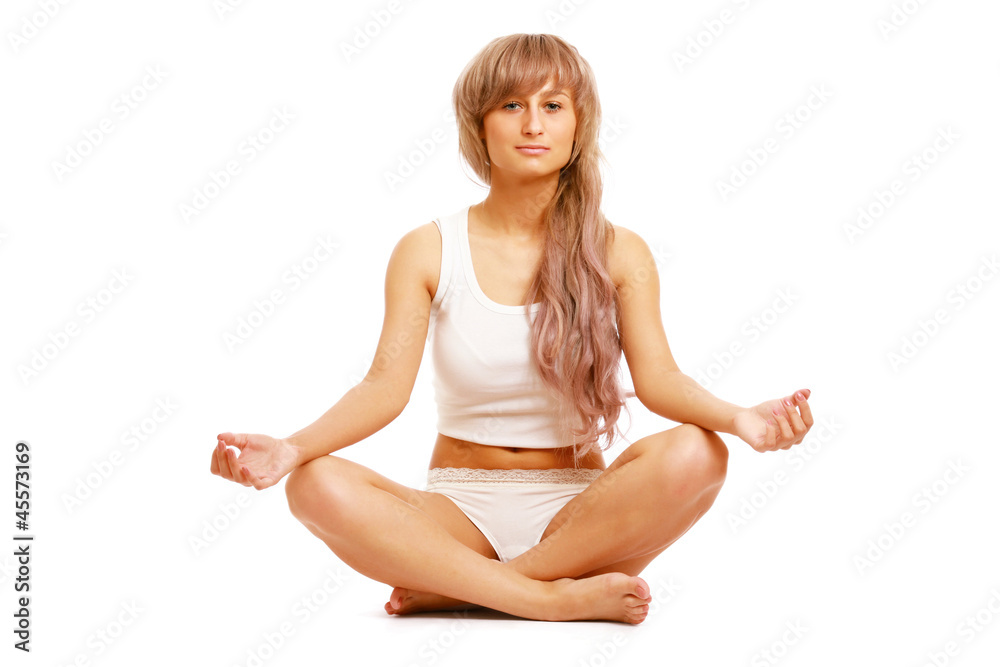 A young woman doing yoga, isolated on white