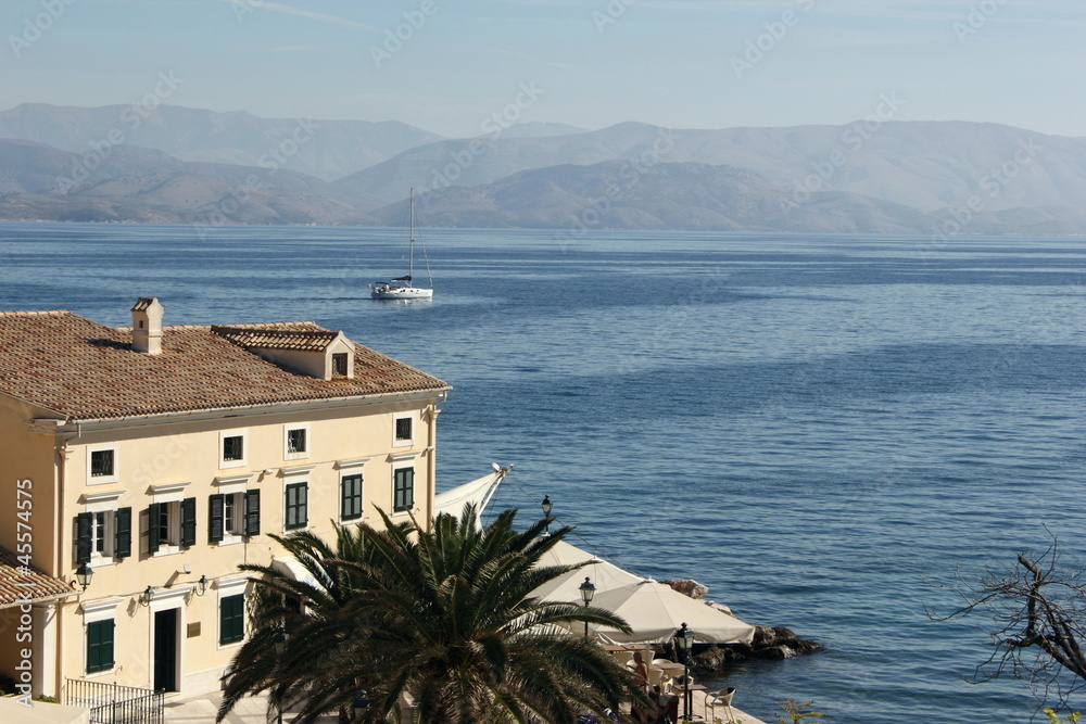 mediteranean  building with blue sea and mountain background