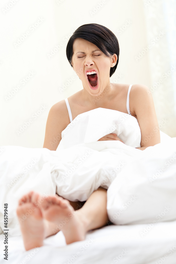 Halfnaked woman is yawning, isolated on white background Halfnaked woman is yawning, isolated on white background