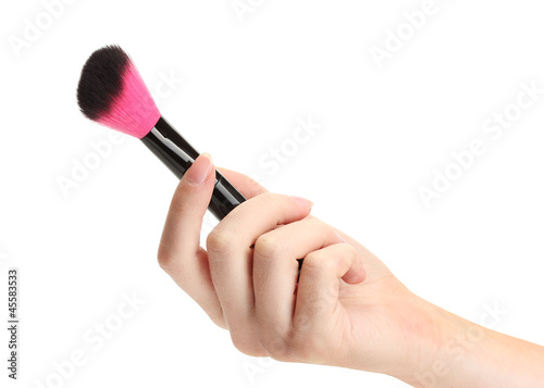 hand with black brush for make-up isolated on white.