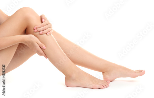 woman holding sore leg  isolated on white