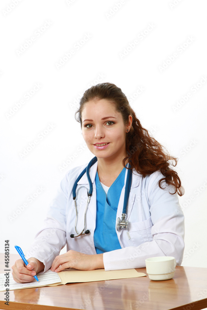 A female doctor working at the desk, isolated on white