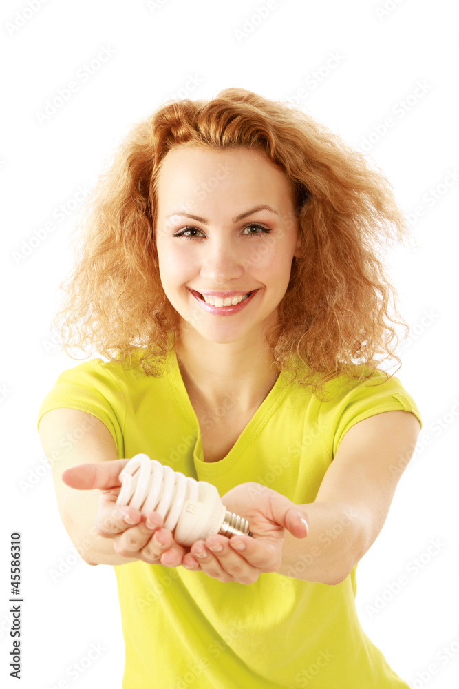 Smiling woman with energy-saving bulb sitting cross Smiling woman with energy-saving bulb sitting cross