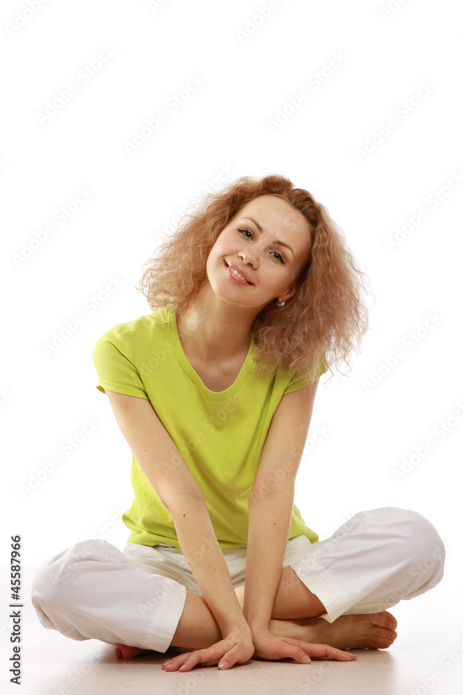 A young girl sitting on the floor, isolated on white