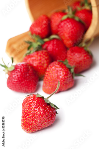 strawberries in basket hanging on a white background