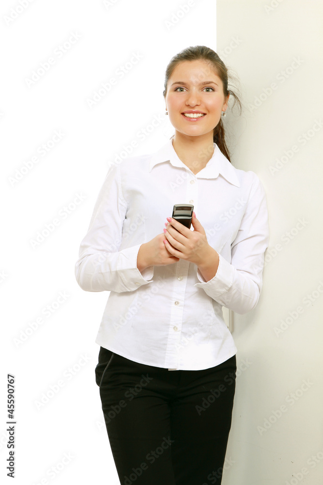 A businesswoman with a mobile phone indoors A businesswoman with a mobile phone indoors