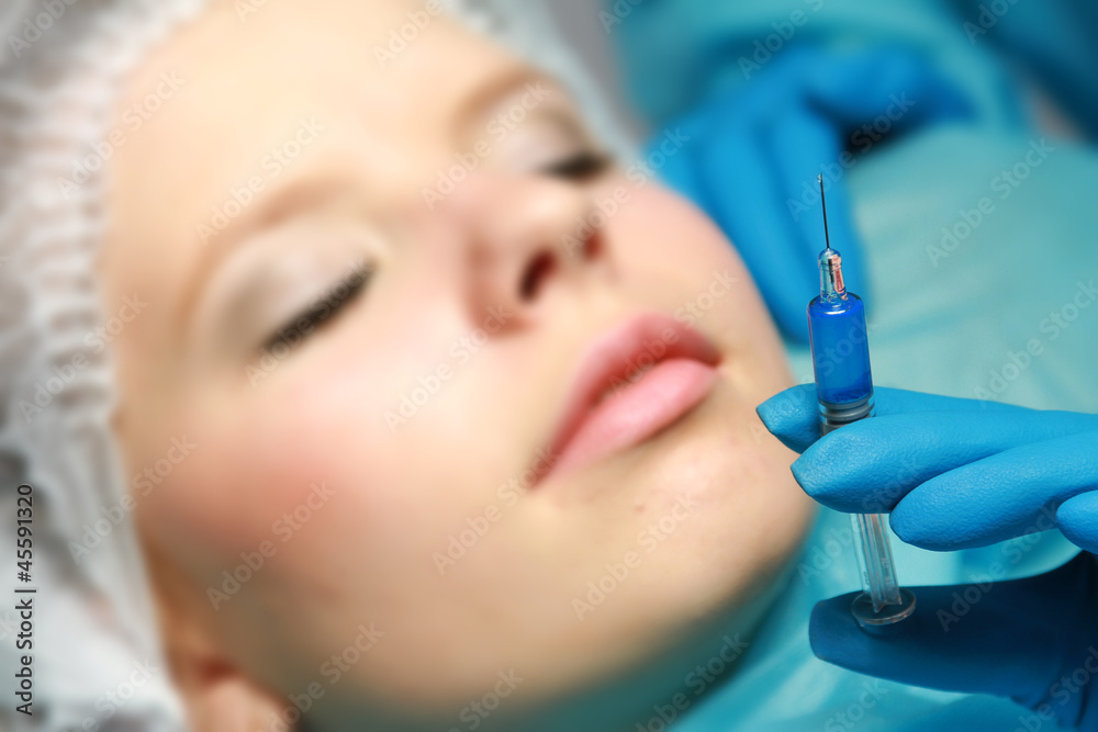A young beautiful woman having an injection A young beautiful woman having an injection