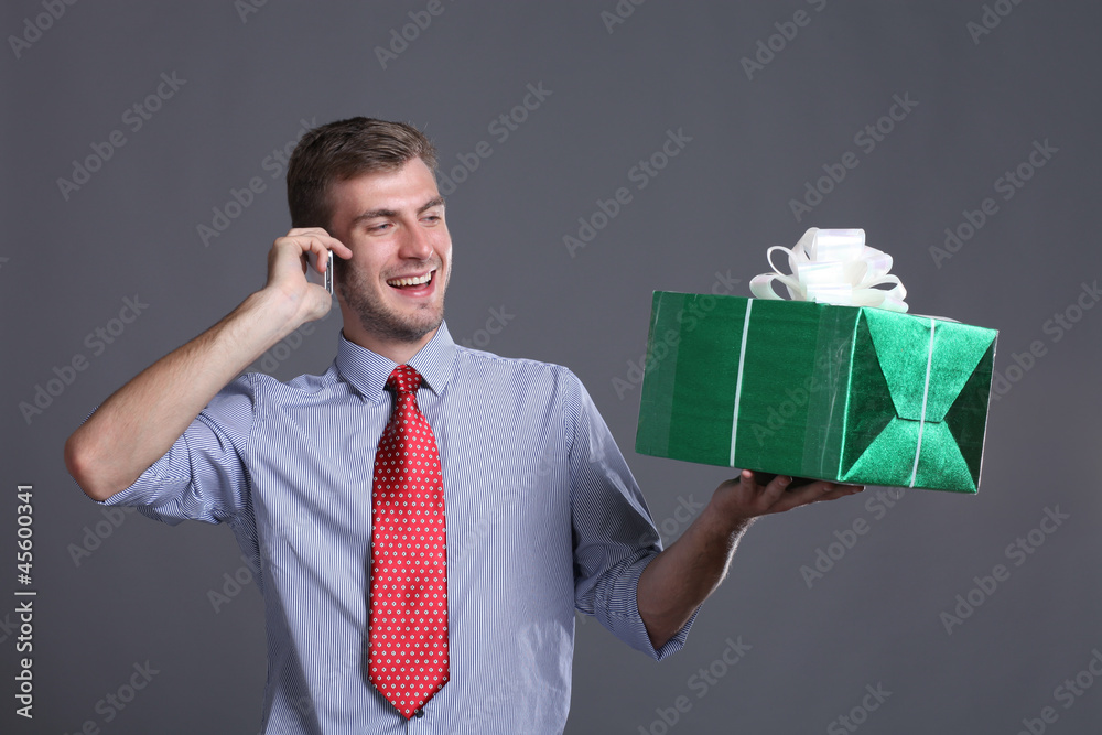 Portrait of young business man with gifts