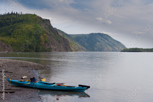 Kayak beached on the shore of Yukon River Canada