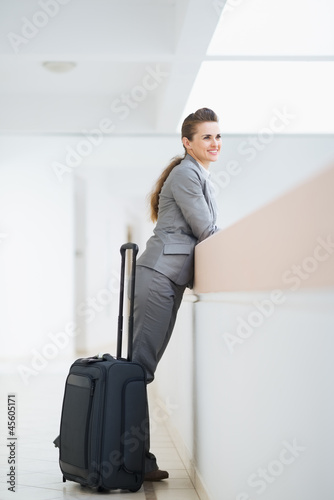 Business woman in business trip with wheel bag