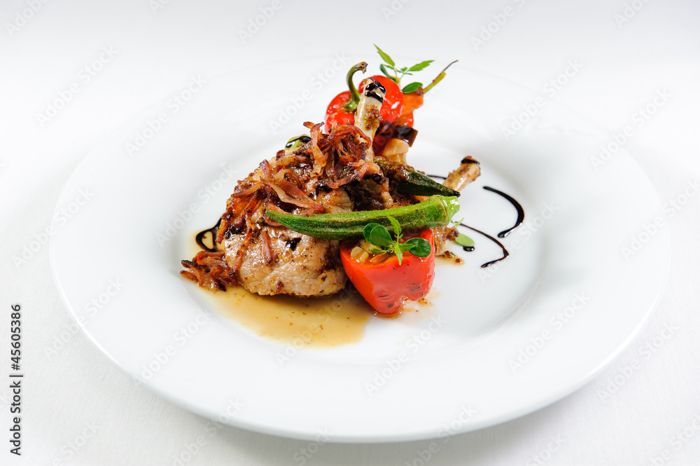 Juicy lamb steak with vegetables on a plate close-up Juicy lamb steak with vegetables on a plate close-up
