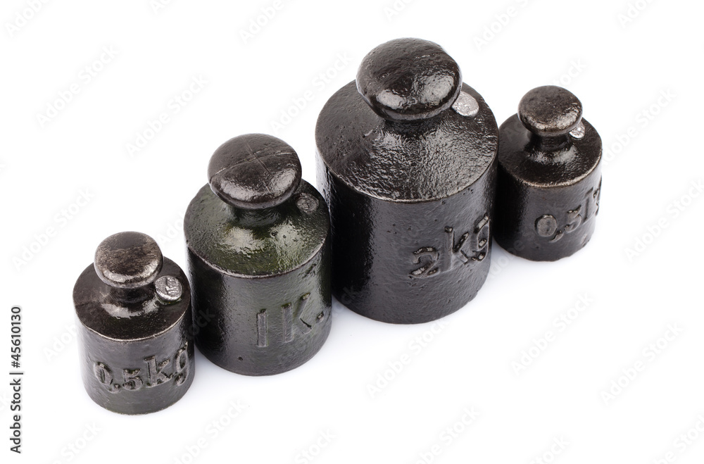 four pieces of old weights isolated on white four pieces of old weights isolated on white