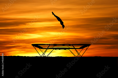 silhouette of trampoline gymnast in sunset
