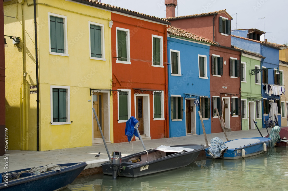 Colourful houses along canal in Burano