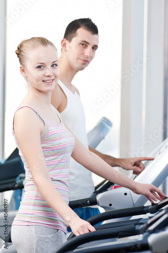 Woman at gym exercising. Run on machine