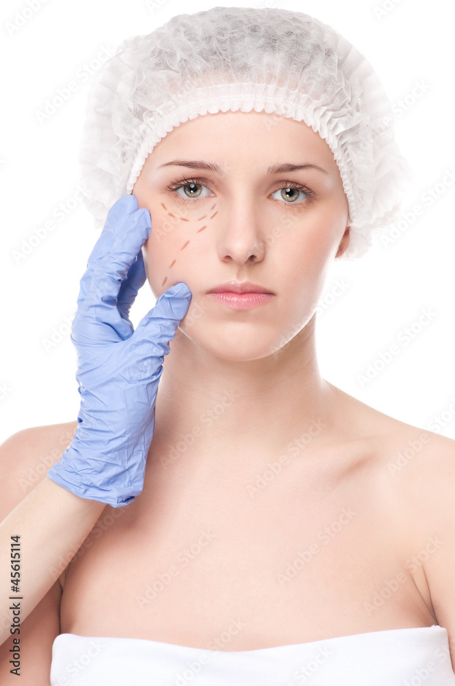 Beautician draw correction lines on woman face Beautician draw correction lines on woman face