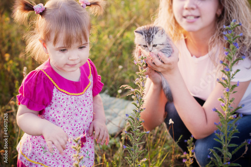 little girl and women with cats outdoor
