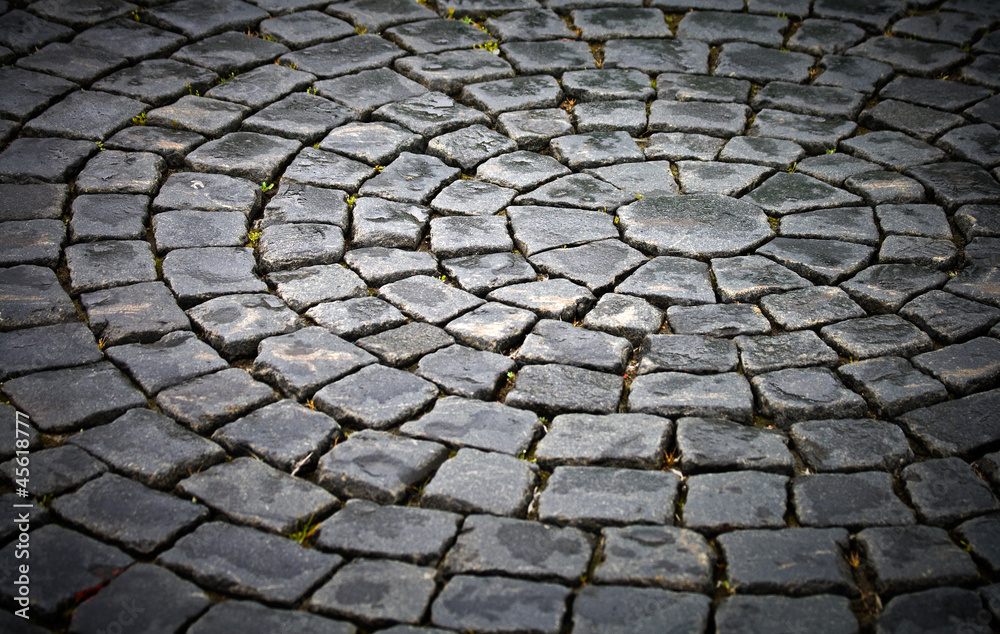Background texture of round cobblestone pavement square