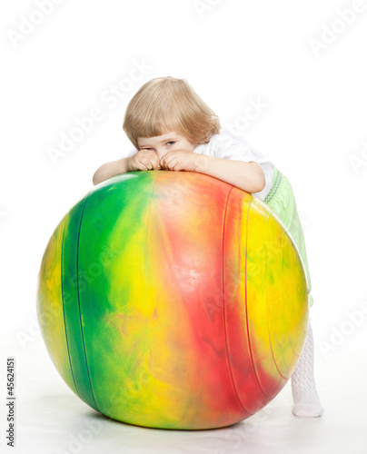 Little girl with a huge fitball - full length portrai