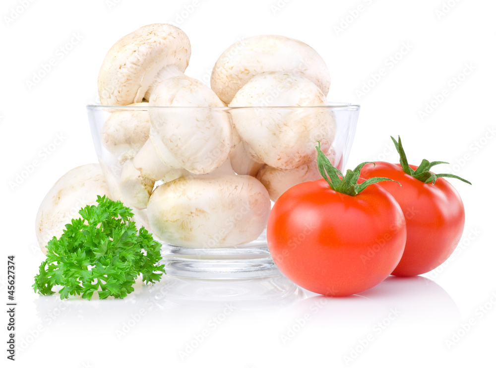 Fresh button mushrooms in Glass bowl, two tomatoes and parsley i