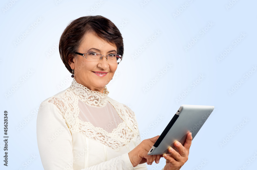 Fototapeta premium Portrait of senior woman with digital tablet