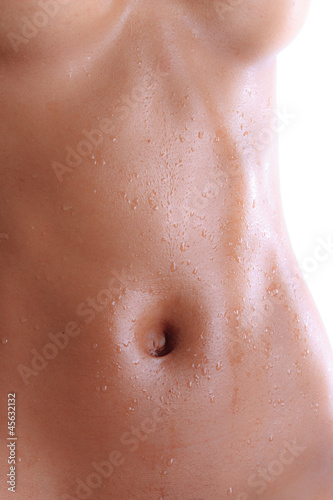 Wet abdomen of a black nude young woman