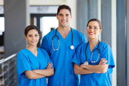 group of young hospital workers in scrubs photo