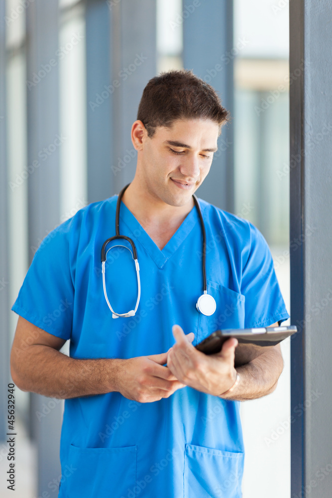 male medical worker using tablet computer in hospital male medical worker using tablet computer in hospital