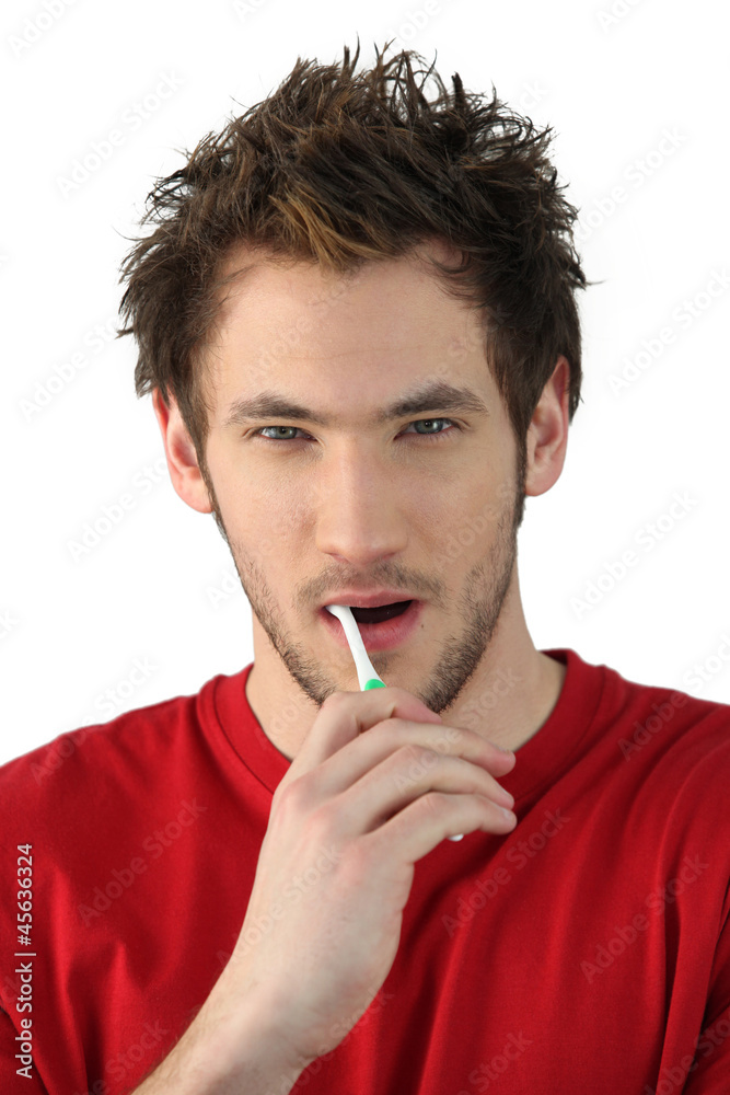 Young man brushing his teeth