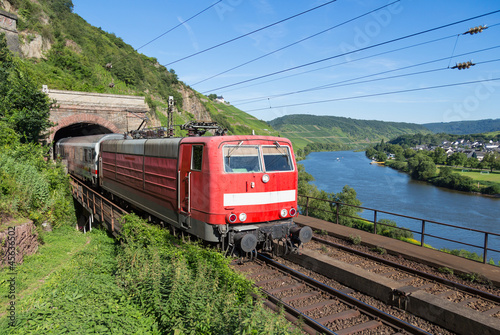 Train leaving a tunnel near the river Moselle in Germany